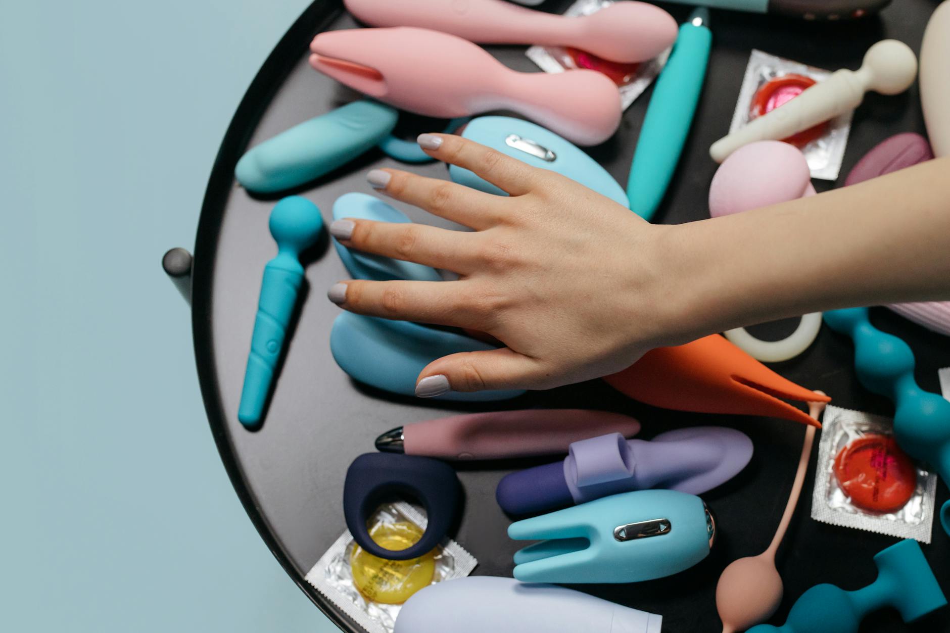 A vibrant collection of lemon clitoral vibrators and various adult toys on a black tray